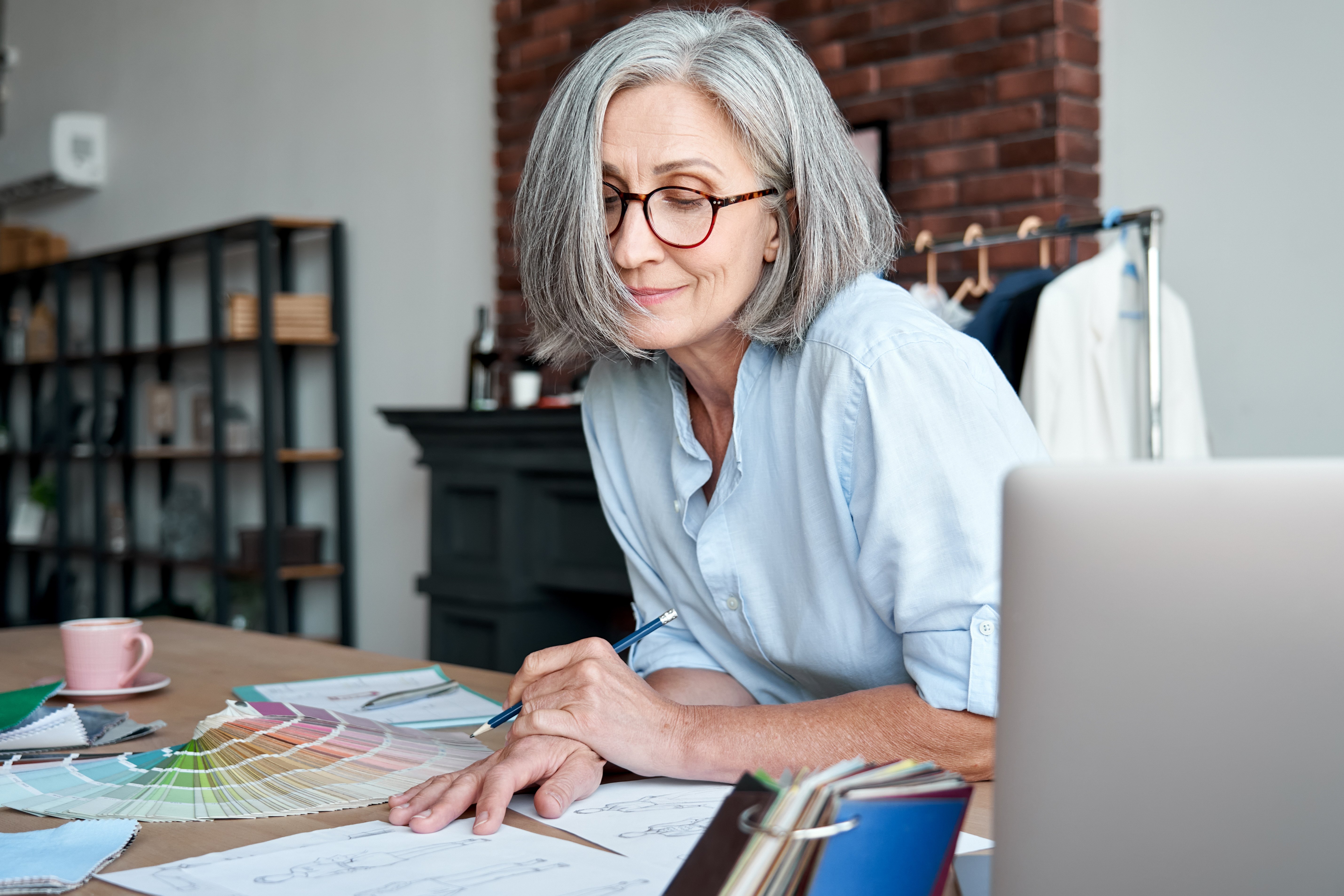 An older female business owner reviewing paperwork