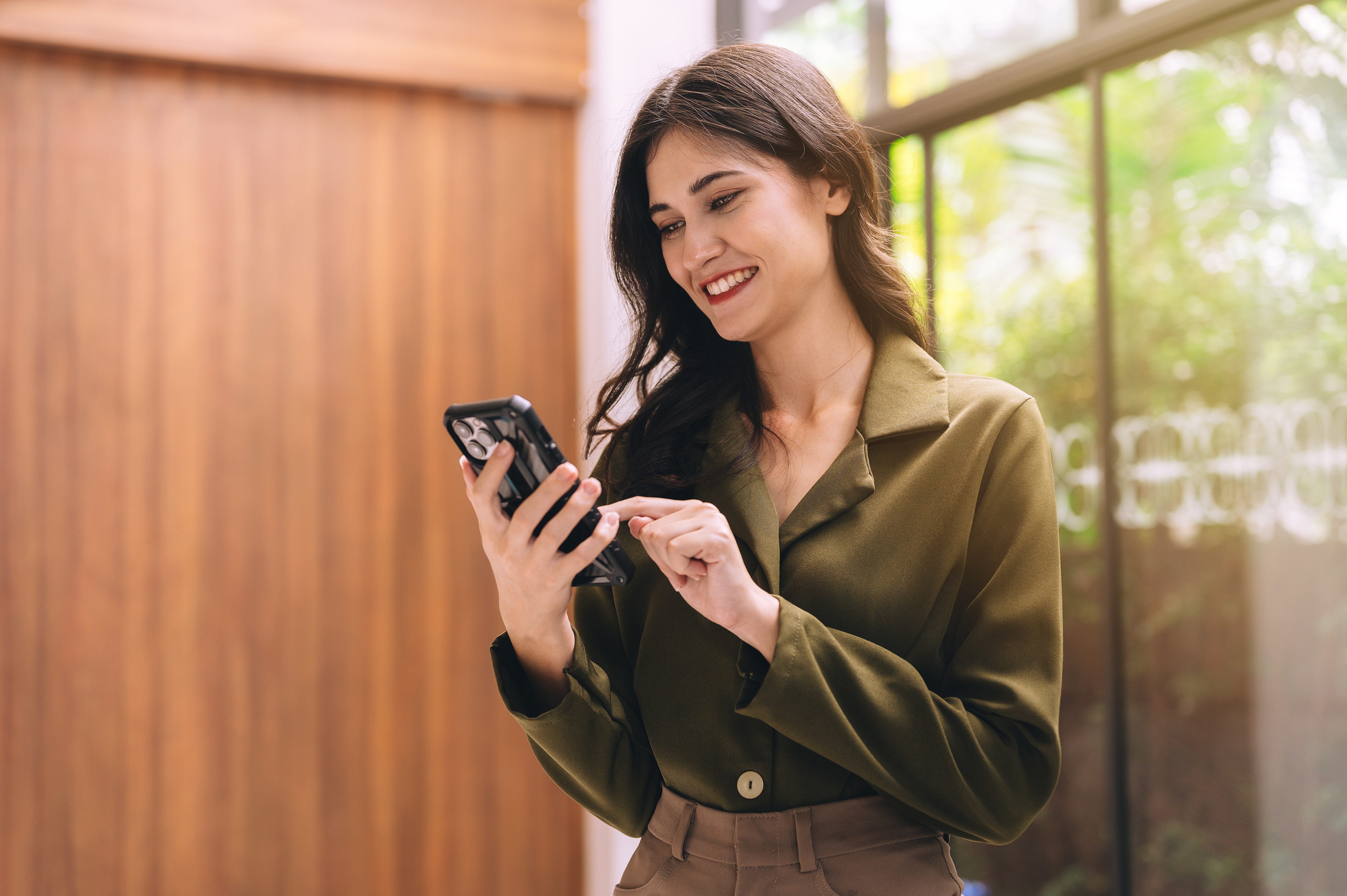 Woman looking at her phone, filling out a form