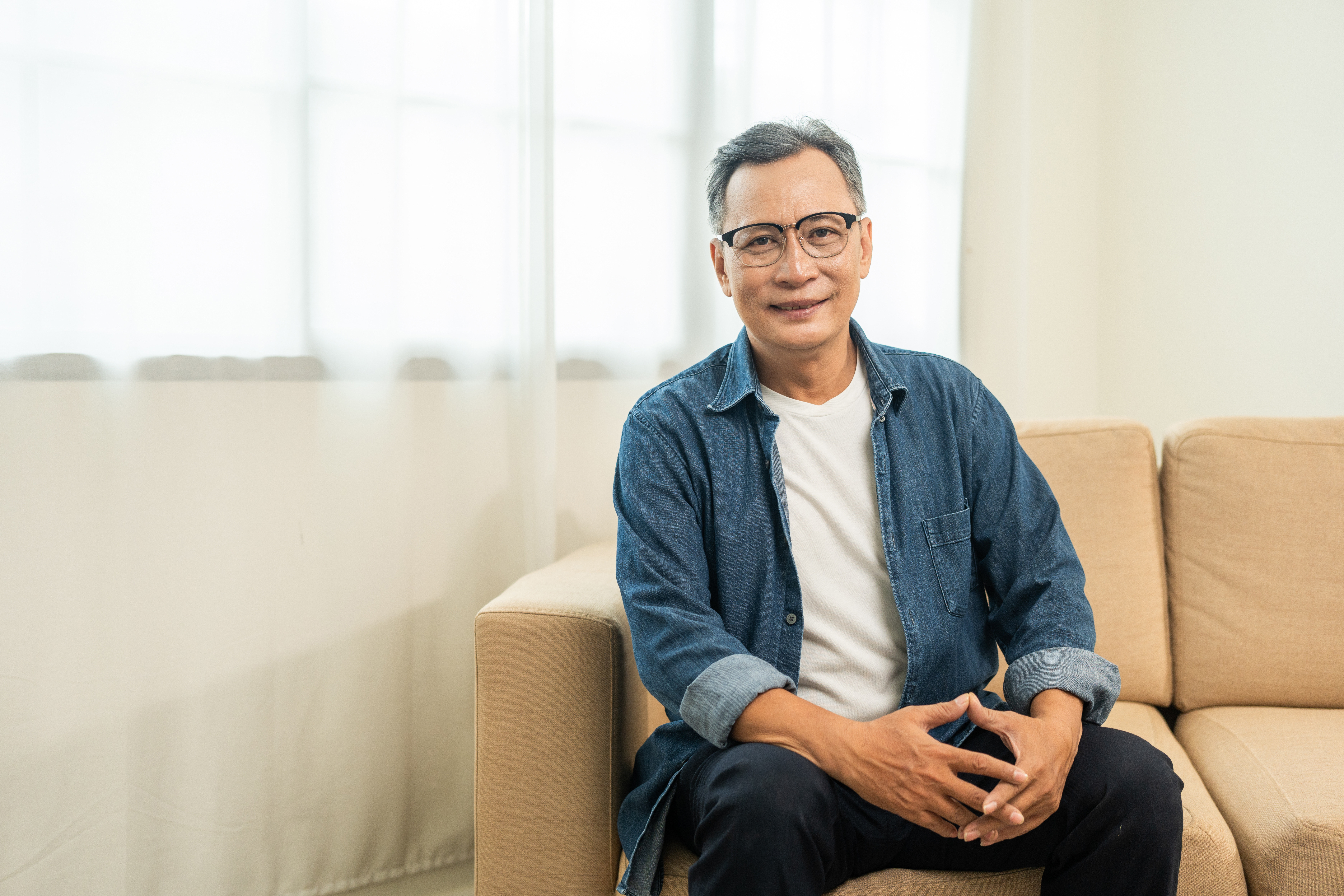 Single individual sitting on couch