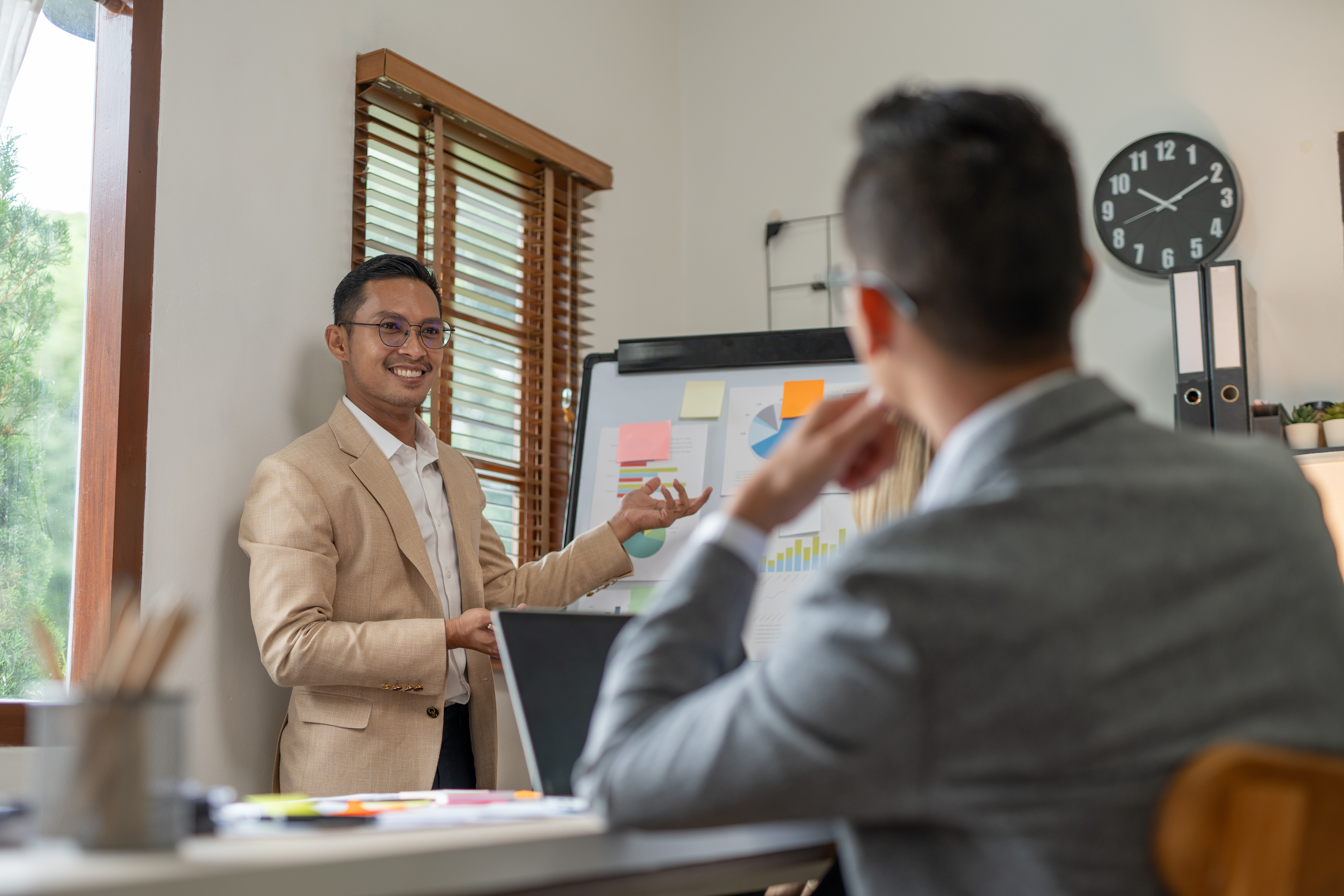 A salesman selling marketplace coverage to a man at a desk