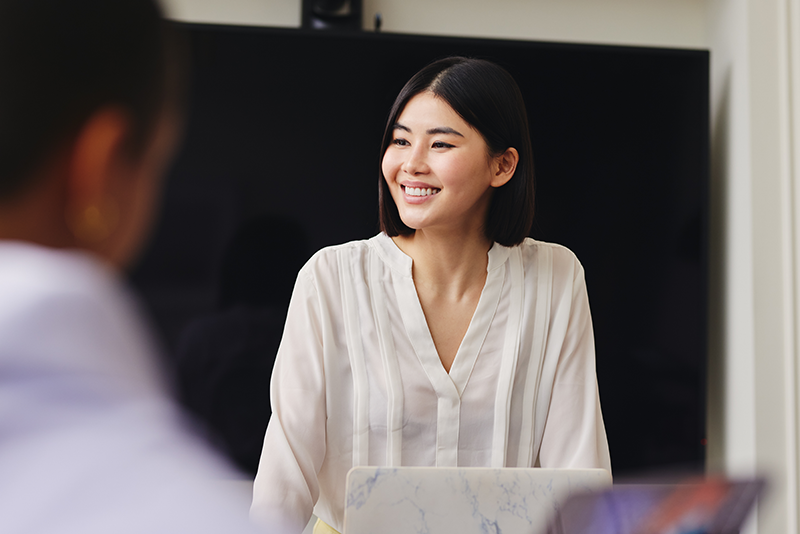 Young woman leading meeting smiling